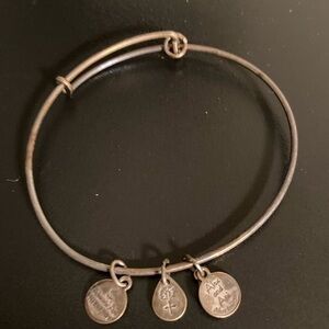 Silver tone bracelet with three charms